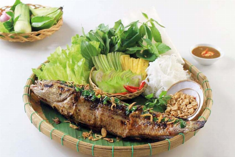 Đĩa bạch tuộc sốt Thái hấp dẫn bày biện cùng rau răm, dưa chuột, sẵn sàng thưởng thức.